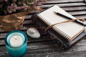 Bound leather journal with pencil and candle.